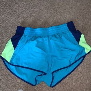 blue, green and dark blue nike running shorts